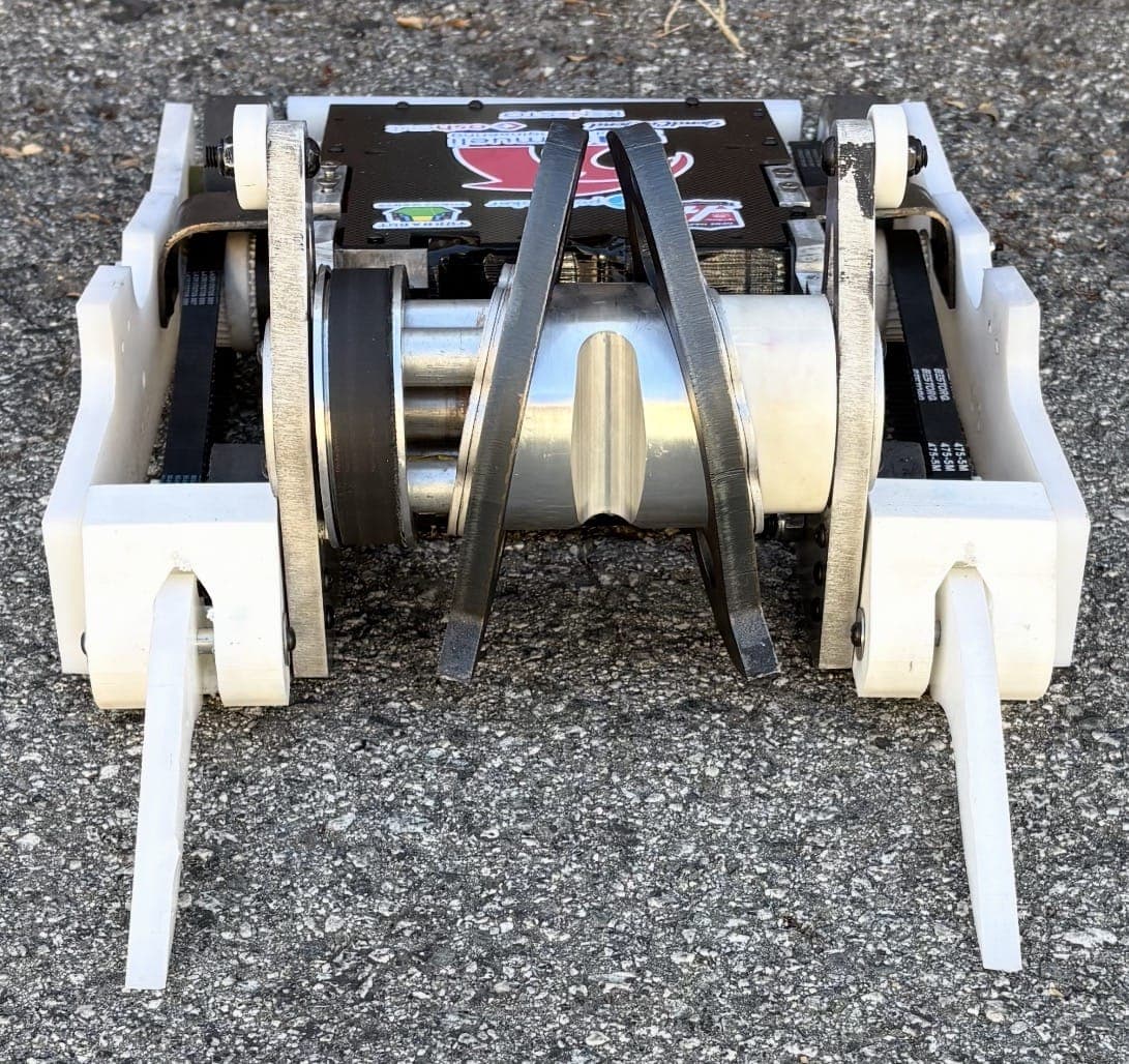 Shear Force from the front: a dark grey cast wheel sits inside the left rail, next to the weapon